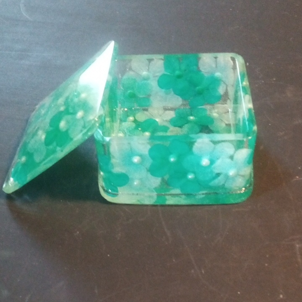 Resin Trinket Box With Teal Flowers Inside It.